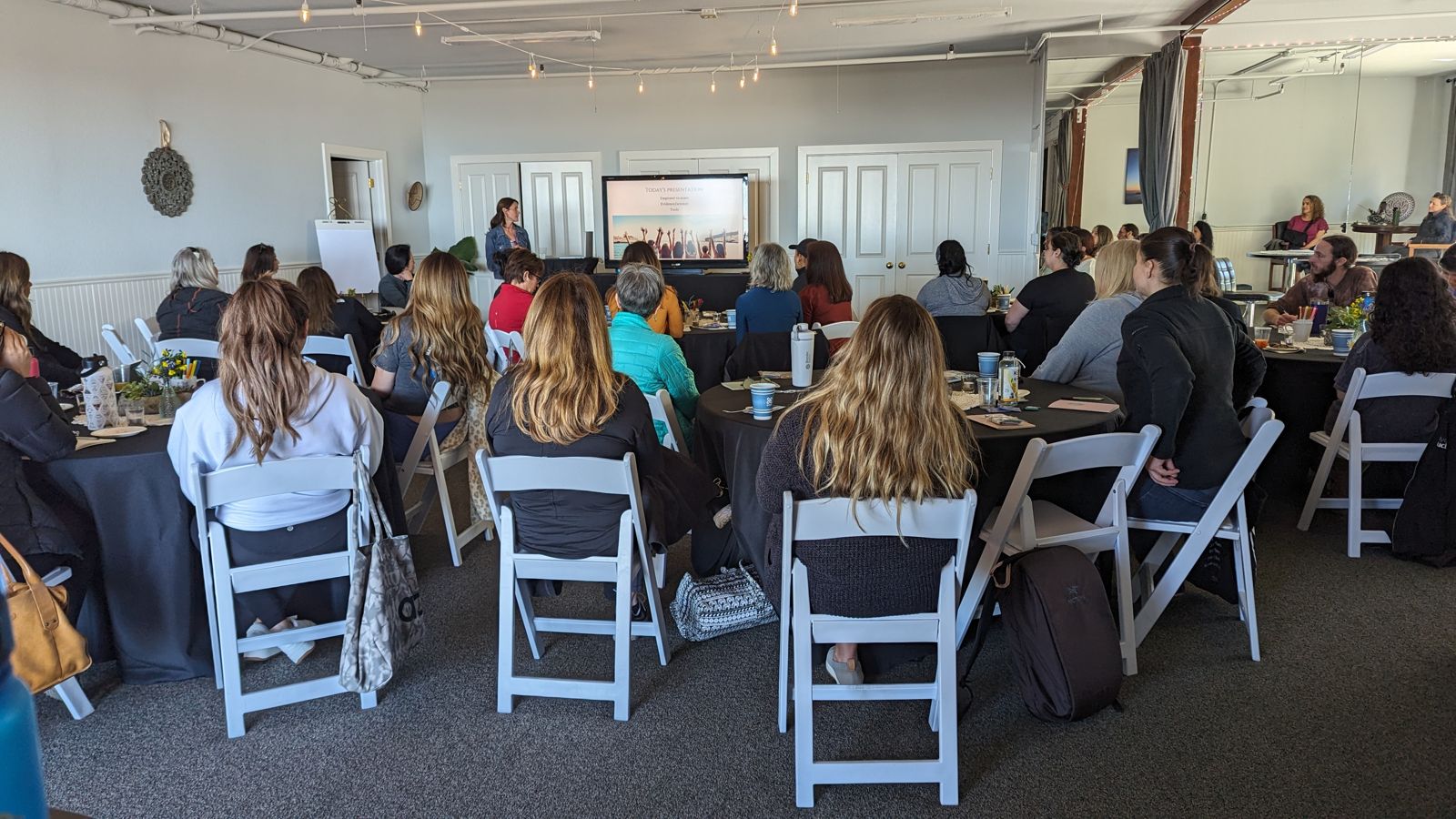 Guests seated for a presentation in the indoor space at Living Well Event Center